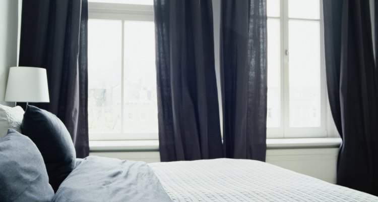 Windows that sit close together do not leave much room for additional curtain rod width.