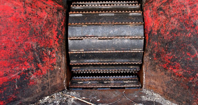 The teeth of the wood chipper pull in items from the hopper.