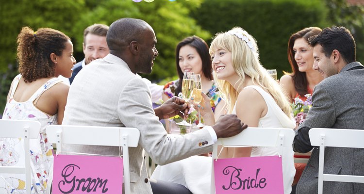 Bride And Groom Enjoying Meal At Wedding Reception