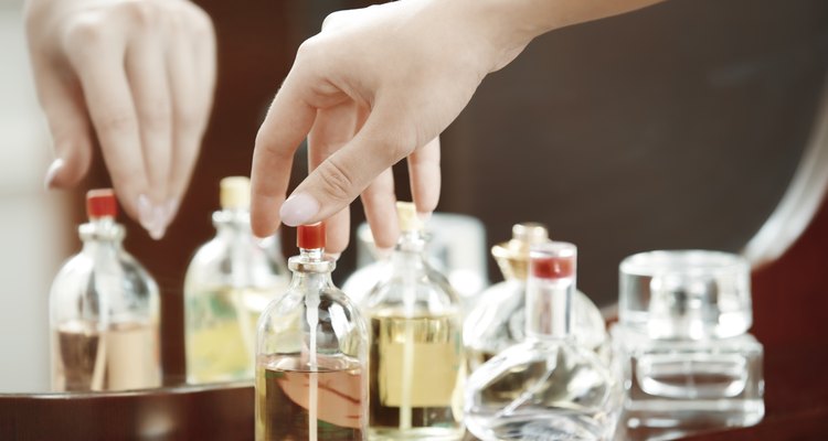 Hands of woman selecting and testing perfume