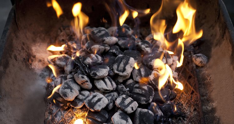 Wait for the flames to burn out before spreading the coals apart.