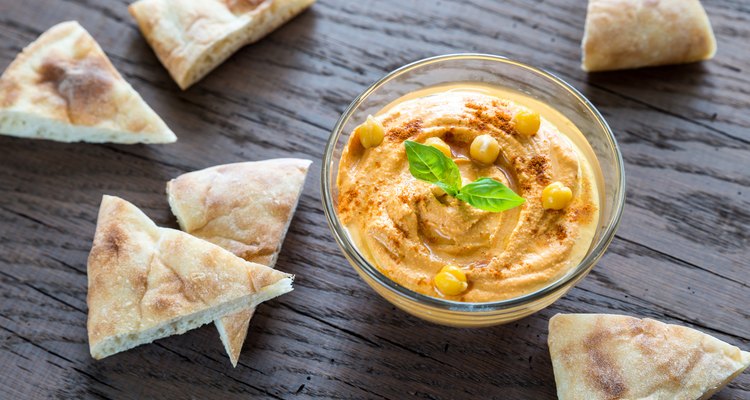 Bowl of hummus with pita slices