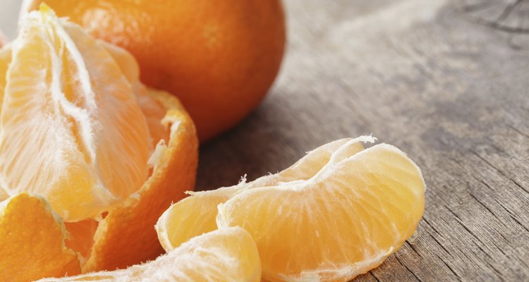 ripe tangerines closeup photo on wooden table