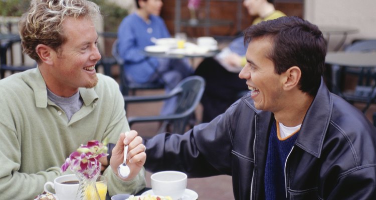 Men eating breakfast at outdoor cafe