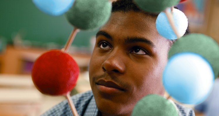 Colour styrofoam balls represent different parts of the atom.