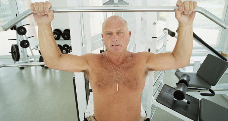 Mature man weight lifting in a gym