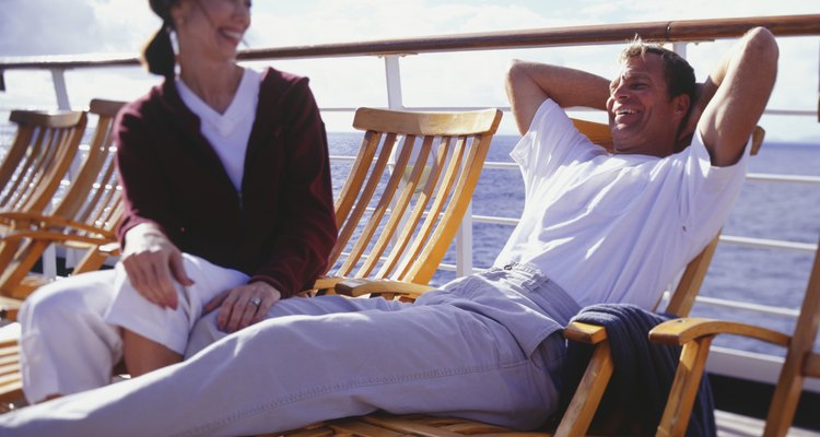 Couple sitting on deck chairs on cruise ship