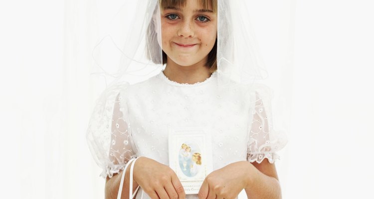 Portrait of a girl (8-10) wearing her first holy communion dress