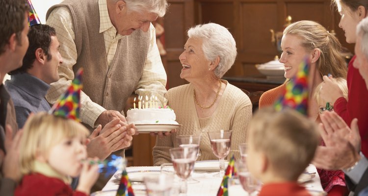 Grandmother getting her birthday cake at the table with family