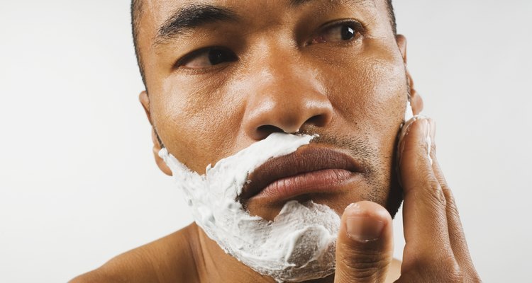 Asian man applying shaving cream
