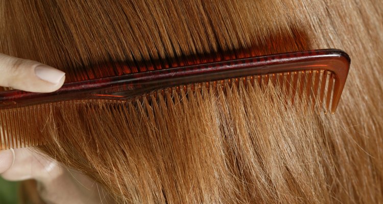 Close-up of woman combing her hair