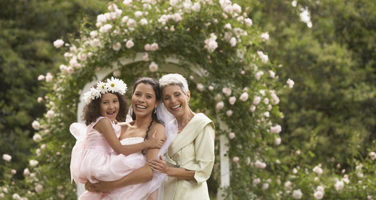 Hispanic bride with mother and young girl smiling