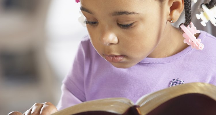 Little girl reading bible