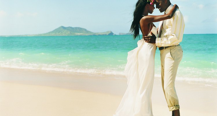 Newlywed Couple Dance Face-to-Face at the Waters Edge on a Beach