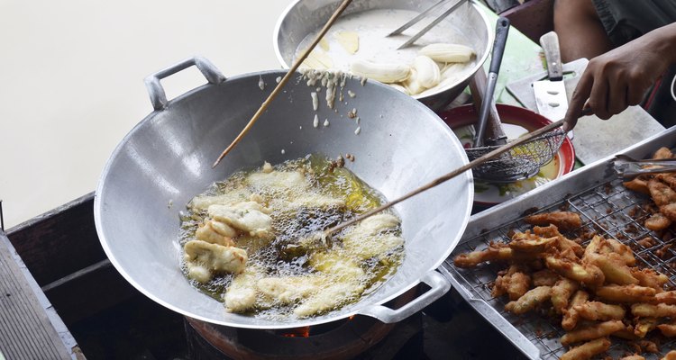 Cooking deep fried sliced banana thai style on boat