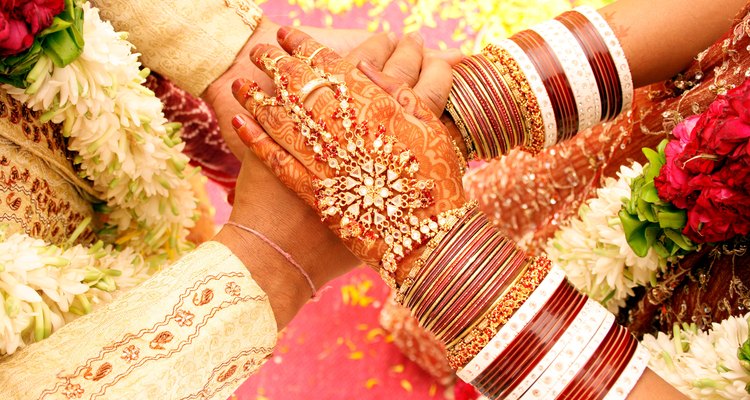 Top angle shot of Bride and groom holding each others hands