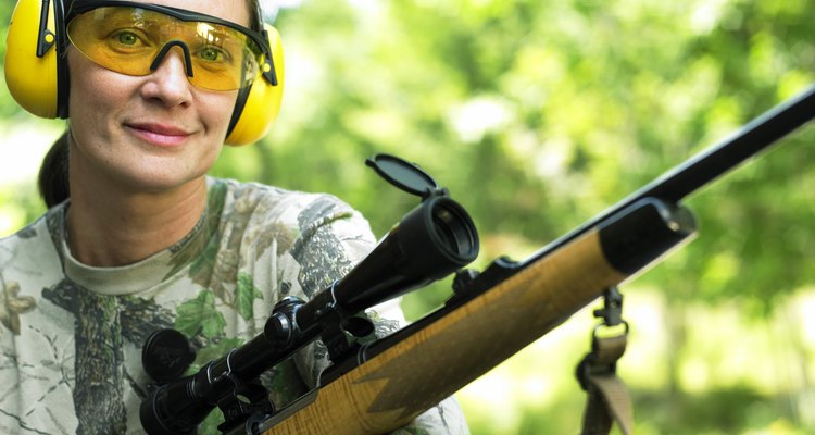 Caucasian Woman Holding A Rifle And Smiling