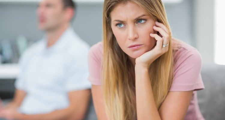 Sad woman thinking on couch after fight with husband