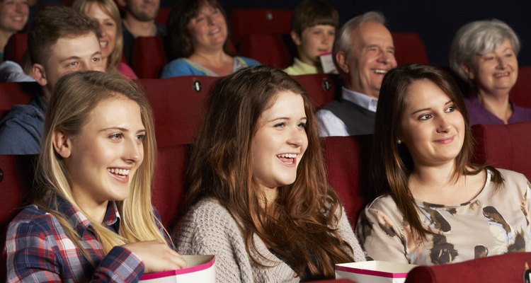 Group Of Teenage Girls Watching Film In Cinema