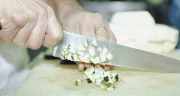 Chef chopping vegetables, mid section