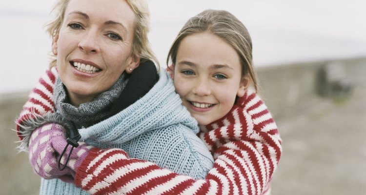 Portrait of a Mother Giving Her Daughter a Piggyback, With both Wearing Warm Clothing