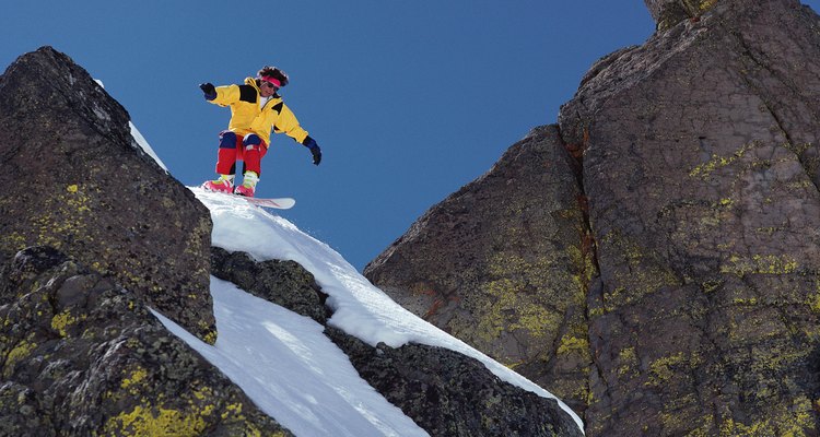 Man snowboarding on rocky slope