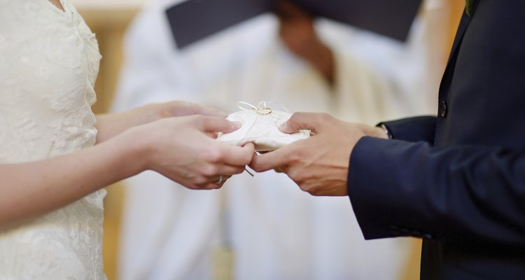 Bride and groom's hands holding wedding rings