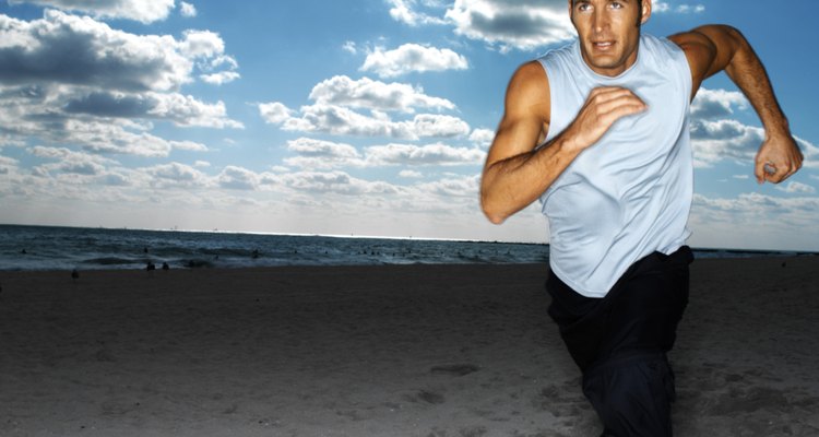 a young man running on the beach