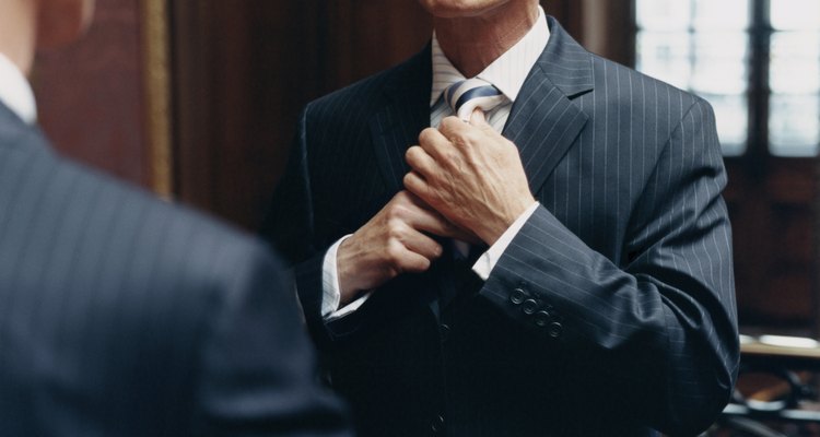 CEO Looking at a Mirror in a Pinstripe Suit Adjusting His Tie