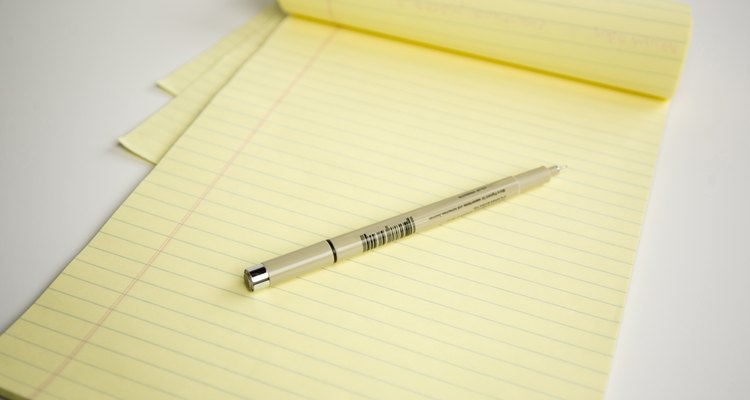 Yellow legal pad with pen