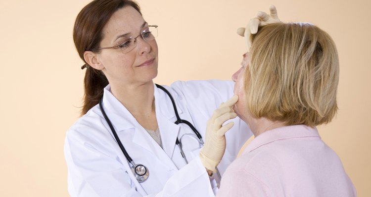 Doctor examining the facial skin rash of a patient