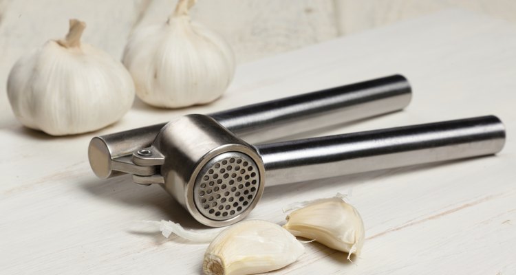 Garlic press and cloves