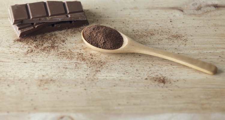 Chocolate Bar and Cocoa Powder on Wooden Surface