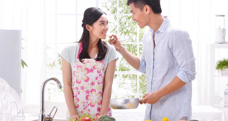 Young couple cooking in kitchen