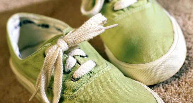 pair of green canvas shoes on carpet