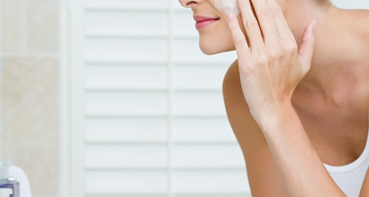 Young woman washing her face