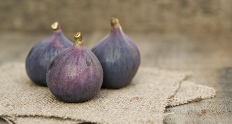 Fresh figs with hessian napkins on wooden background