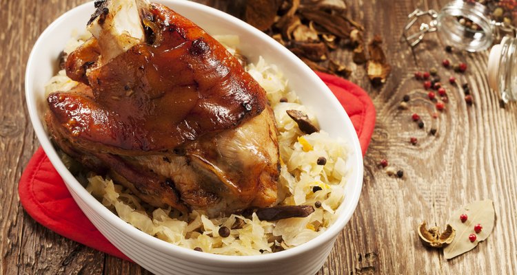 Roasted knuckle of pork with boiled cabbage, bread, horseradish