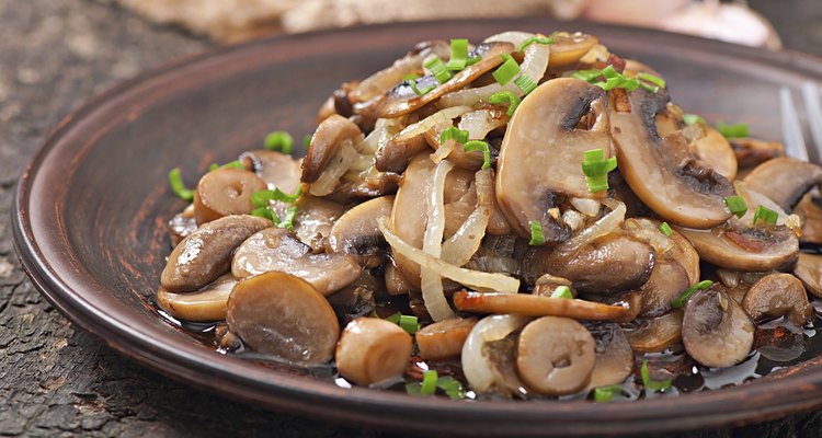 Fried mushrooms and onions on a ceramic plate