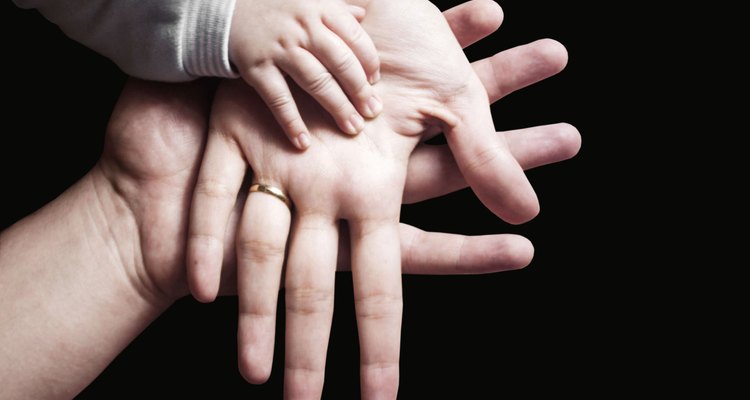 Hands of a family on black background