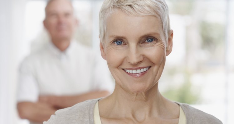 Smiling mature lady with man in the background