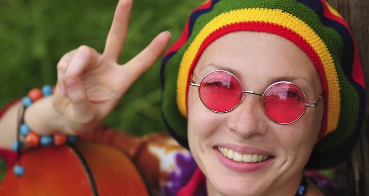 Young hippiey woman making peace sign