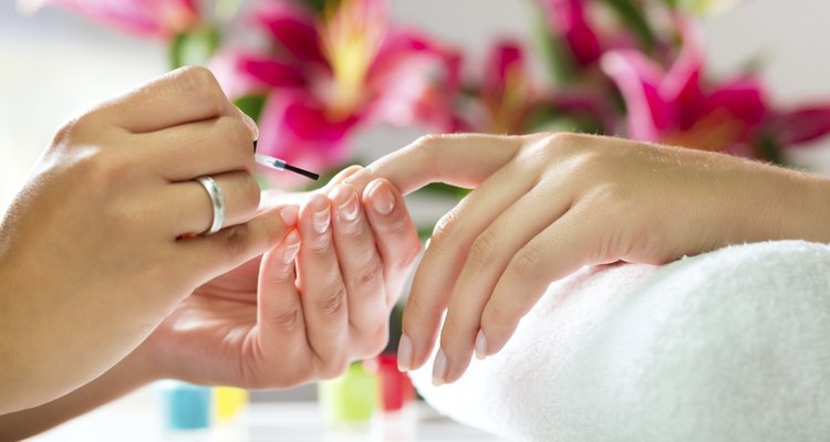 Woman in nail salon receiving manicure