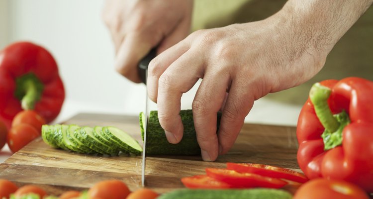 man cutting vegetables for salad