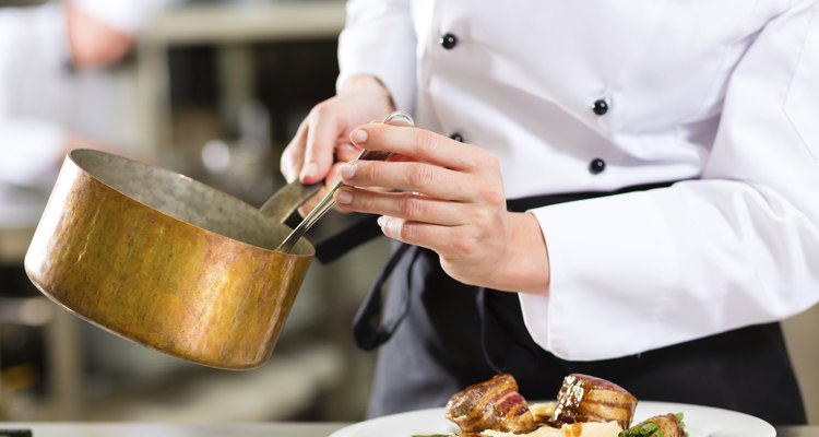 Chef in hotel or restaurant kitchen cooking