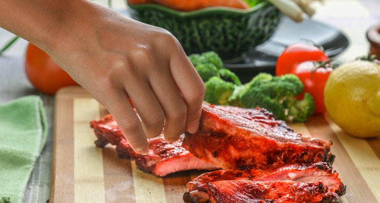 woman's hand pick up a BBQ Spare ribs