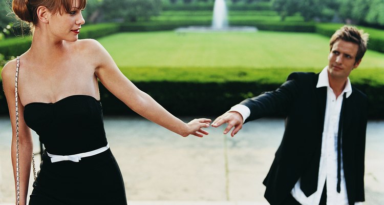 Young Couple in Evening Dress Parting in Formal Garden