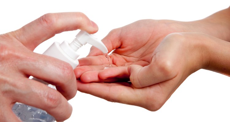 adult giving child hand sanitizer