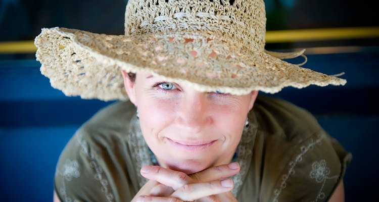 Woman with straw hat flirts