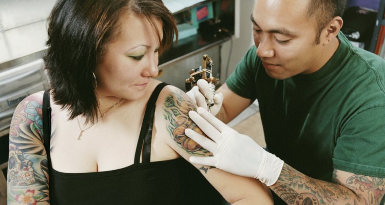 Tattooist Tattooing a Woman's Arm